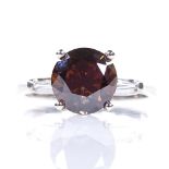 A 3.05ct cognac brown solitaire diamond ring, white metal setting with tapered baguette-cut