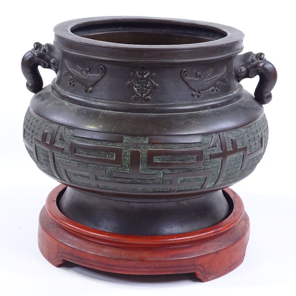 A Chinese bronze incense burner, cast dragon design handles, with relief decorated frieze, rim - Image 2 of 3