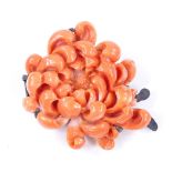 A carved coral floral brooch, with silver settings, brooch length 31.7mm, 6.9g