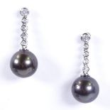 A pair of 14ct white gold black Akoya pearl and diamond drop earrings, total diamond content