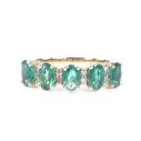 A 14ct gold emerald and diamond half-hoop ring, total oval-cut emerald weight approx 1.11ct, total