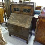 A Liberty Arts and Crafts oak bureau bookcase, possibly Culloden range, with leadlight panelled