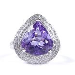 A 14ct white gold amethyst and diamond cluster dress ring, with diamond set shoulders and pierced