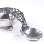 An Arts and Crafts silver caddy spoon and bowl, with pierced stylised floral handle, unmarked but