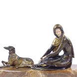 An Art Deco style gilded and patinated spelter figure of a woman with a Borzoi dog, on onyx plinth