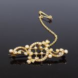 An unmarked gold split-pearl brooch, with pierced openwork lattice settings, brooch length 40mm, 4.