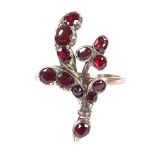 An unmarked gold flat-top garnet floral ring, setting height 24.9mm, size J, 2.8g