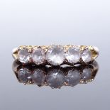 An unmarked gold 5-stone graduated white sapphire half-hoop ring, setting height 4.5mm, size K, 2.6g