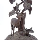 A patinated bronze antelope standing under a tree, circa 1900, unsigned, height 20cm
