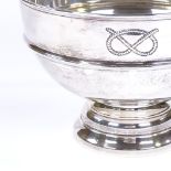 A large circular silver table centre fruit bowl, with relief embossed overhand knot motif, hallmarks