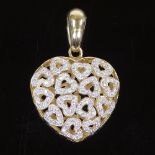 A large 9ct gold cubic zirconia heart-shaped pendant, with pierced heart-shaped settings, height