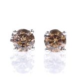 A pair of 14ct white gold 1.03ct solitaire cognac brown diamond earrings, with stud fittings,