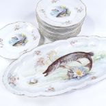 A Continental porcelain fish set, comprising a serving dish, 57cm across, and 11 x 24cm plates