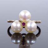 An unmarked gold pearl trio and ruby ring, setting height 12mm, size K, 2.9g