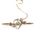 An Art Nouveau 15ct gold peridot and split-pearl sweetheart bar brooch, hallmarks Chester 1913,