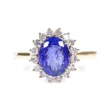 An 18ct gold tanzanite and diamond cluster ring, oval-cut tanzanite approx 1.92ct, total diamond