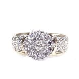 A 9ct gold diamond cluster flowerhead ring, with diamond set shoulders, setting height 9.4mm, size