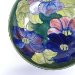 A Moorcroft floral pattern fruit bowl, original paper label and signature under base, diameter 26.