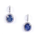 A pair of 14ct white gold sapphire and diamond cluster drop earrings, with stud fittings and diamond