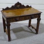 An oak side table with carved lion mask handles, 3'6"