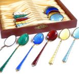 A set of 12 Danish sterling silver-gilt and coloured enamel coffee spoons, with engine turned