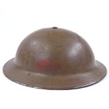 A Second War Period British Army tin helmet dated 1938