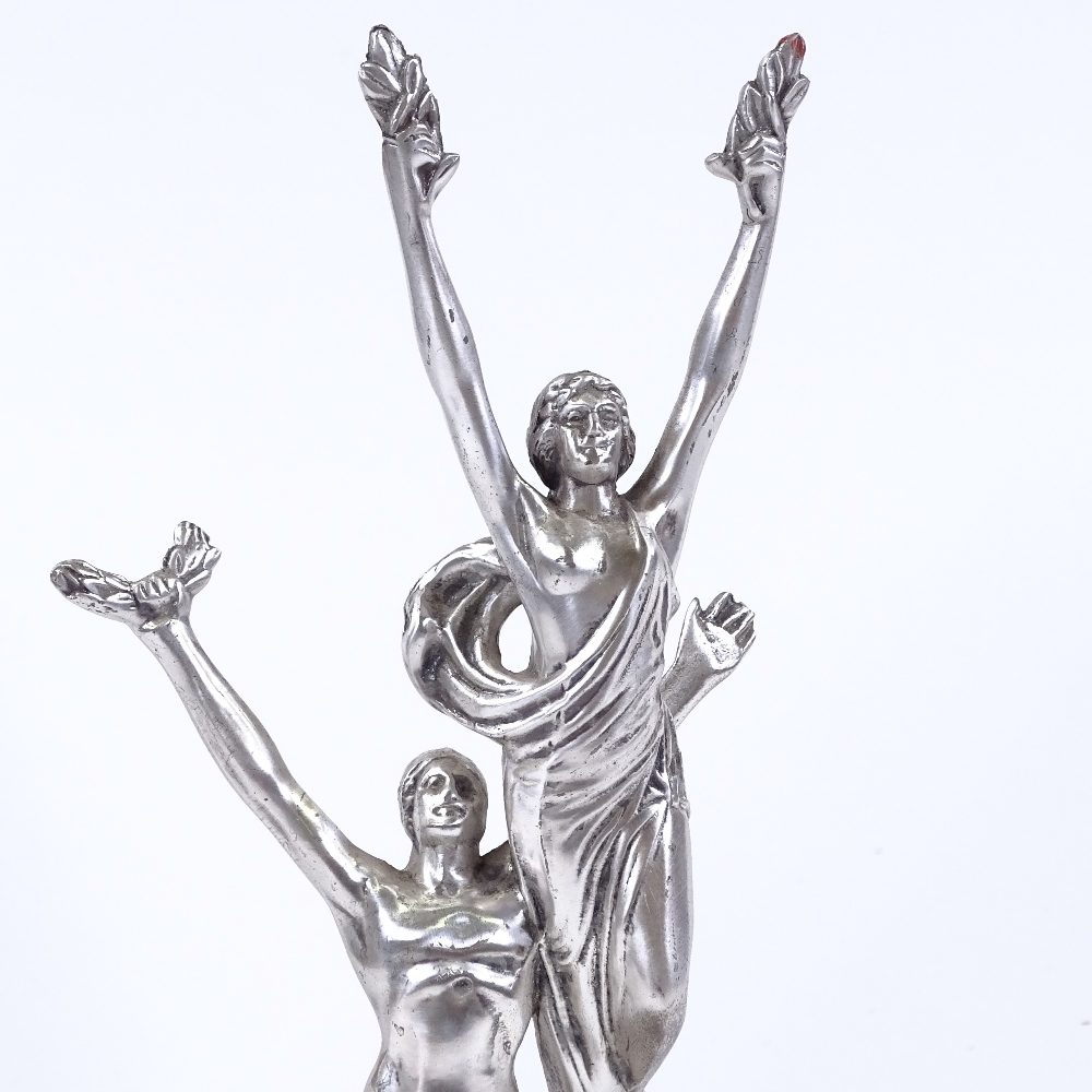 A silver patinated bronze Classical sculpture depicting 2 figures holding laurel wreaths, on