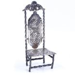 An Antique Continental white metal miniature chair, with engraved lattice and bird decoration,