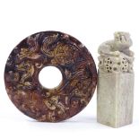 A Chinese relief carved stone disc, diameter 10cm, and a carved stone seal (2)