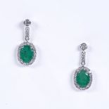 A pair of 14ct white gold emerald and diamond drop earrings, with stud fittings, total oval-cut