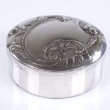 A modern circular silver-lidded trinket box, with relief embossed foliate lid, diameter 7cm, 2oz