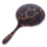A tortoiseshell and silver pique inlaid dressing table hand mirror, indistinct maker's marks,