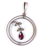 An Edwardian 9ct gold garnet and split-pearl flower pendant, openwork settings, pendant height