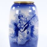 A large Royal Doulton pottery vase, blue transfer design of a young woman playing a guitar, with