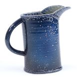Walter Keeler (British born 1942), a blue salt glaze leaning jug, height 17cm