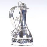 A large Victorian Gothic revival silver flagon, of baluster form, with fleurs de lis handle