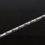 A 9ct white gold diamond set line bracelet, band width 3.5mm, bracelet length 19cm, 7.5g