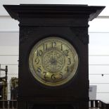 A Scottish Arts and Crafts period carved oak longcase clock, with brass dial and original brass