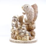 A large modern Chinese bone carving depicting 2 figures with a fish, overall height 51cm