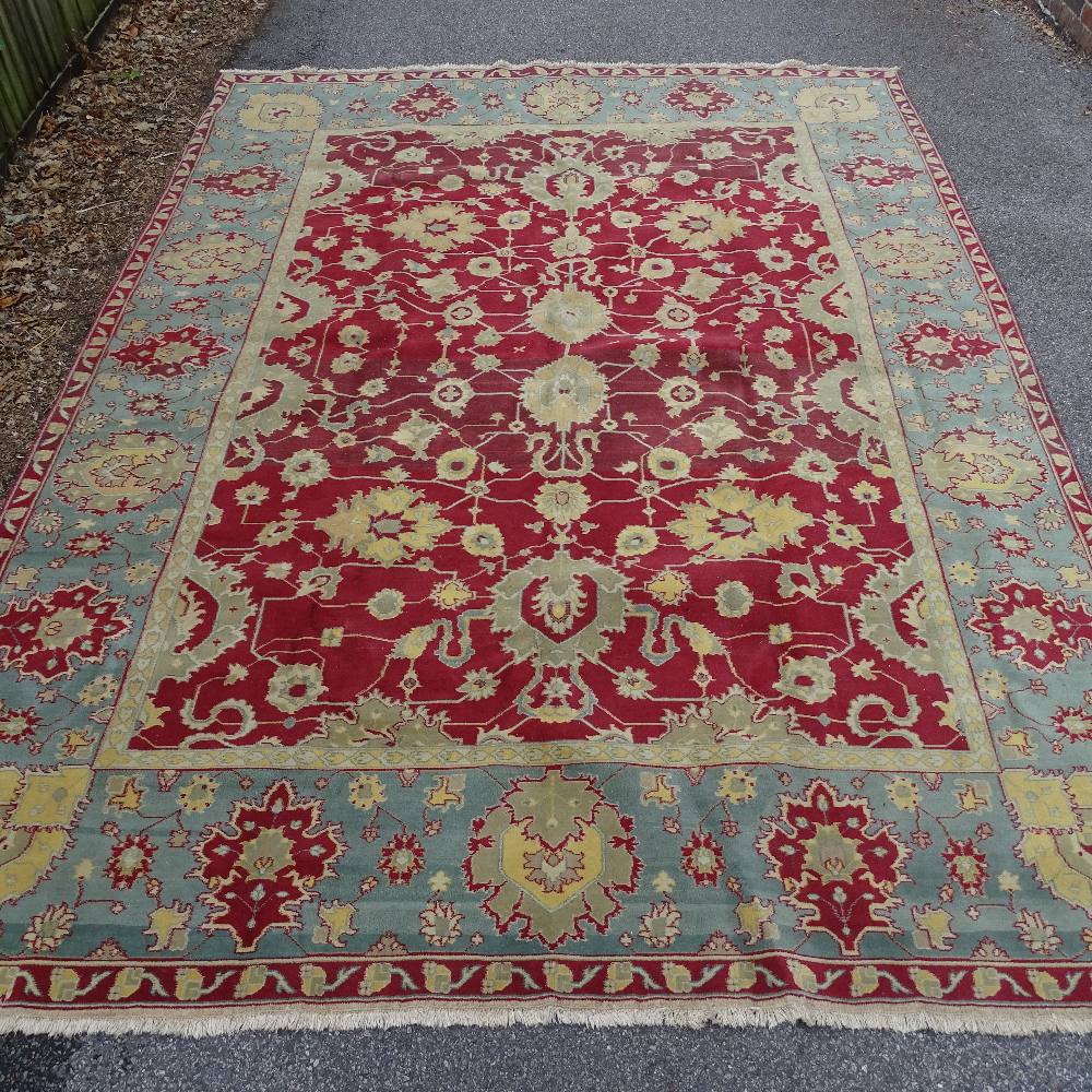 A large red ground handwoven Oshak rug, circa 1950, 370cm x 274cm