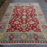 A large red ground handwoven Oshak rug, circa 1950, 370cm x 274cm