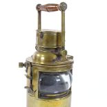 A heavy gauge brass lantern with bull's eye lens and swing handle, height 34cm