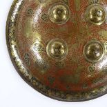 An Islamic engraved brass and enamel shield, diameter 37cm
