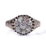 An 18ct gold diamond cluster panel ring, with engraved foliate shoulders, maker's marks J Y and S,