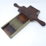 A good quality Georgian mahogany and brass pill roller