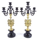 A pair of parcel gilt-bronze candelabra, circa 1900, on turned slate bases, height 46cm