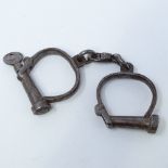 A Victorian set of handcuffs by Hiatt, with key