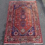 A handmade Persian red and blue ground rug, 6'5" x 4'6"