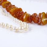 A graduated single-strand pearl necklace, together with a graduated string of Baltic amber (2)