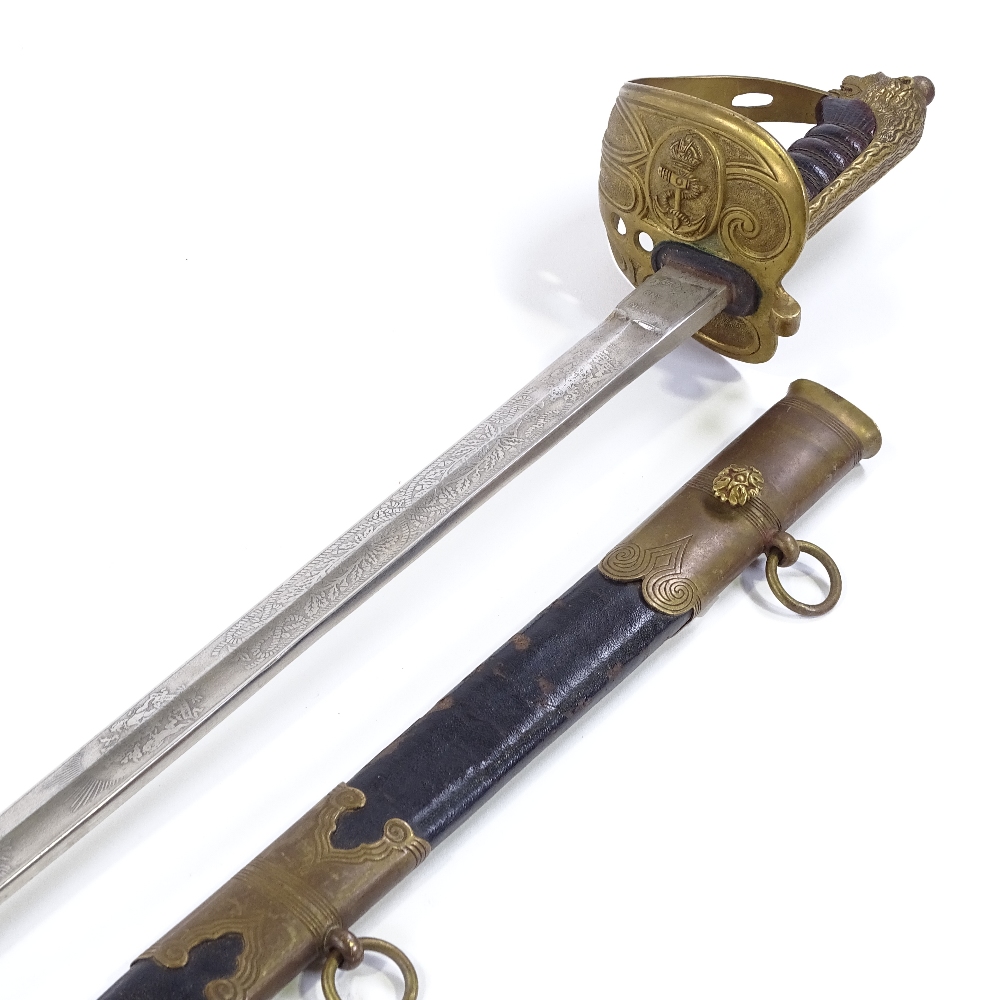 A Navy Officer's sword by Manton & Co, with etched blade, brass bowl hilt with leather grips, and